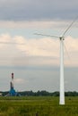 View of wind farm or wind park, with high wind turbines for generation electricity. Green energy concept