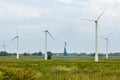 View of wind farm or wind park, with high wind turbines for generation electricity. Green energy concept