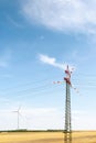 View of a wind power plant on a background of blue sky and fields with grain crops Royalty Free Stock Photo