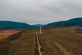 View of a wind turbine in the mountains in the background, Alternative energy, Ukrainian windmill in a field in the Carpathian Royalty Free Stock Photo