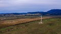 View of a wind turbine in the mountains in the background, Alternative energy, Ukrainian windmill in a field in the Carpathian Royalty Free Stock Photo