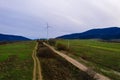 View of a wind turbine in the mountains in the background, Alternative energy, Ukrainian windmill in a field in the Carpathian Royalty Free Stock Photo