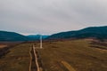 View of a wind turbine in the mountains in the background, Alternative energy, Ukrainian windmill in a field in the Carpathian Royalty Free Stock Photo