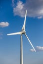 View of a wind turbine on top of mountains, blue sky as background View of a wind turbine on top of mountains, blue sky as Royalty Free Stock Photo