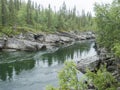 View of winding Tarra river with birch bush, gravel, grass and granite rock. Northern landscape in Swedish Lapland at Royalty Free Stock Photo