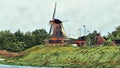 View of a windmill on the riverbank Royalty Free Stock Photo