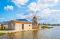 View of a windmill in the Saline di Trapani e Paceco natural reserve near Trapani, Sicily, Italy Royalty Free Stock Photo