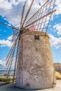 View of a windmill in the Saline di Trapani e Paceco natural reserve near Trapani, Sicily, Italy Royalty Free Stock Photo