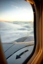 View from the window of an airplane with beautiful cloudy sky at sunrise. travel concept Royalty Free Stock Photo