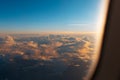 View through window of airplane during the flight. Beautiful sunrise above clouds Royalty Free Stock Photo