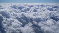 View from the window of an airplane on white fluffy clouds over the city on a clear sunny day, blue sky. Vacation travel by plane Royalty Free Stock Photo