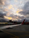 View from the window of the airport at sunset. view from the window on the wing of the plane and the airport at sunset. Royalty Free Stock Photo