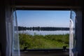 View from a window of camper to beautiful lake landscape