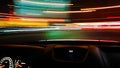 View from the window of a car driving fast along the  street of a night city. Royalty Free Stock Photo