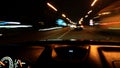 View from the window of a car driving fast along the  street of a night city. Royalty Free Stock Photo