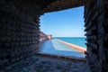 View from the window or casemate of an old brick military fort. Ocean and clear summer sky outside. Fort Jefferson