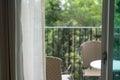 View from the window a chair and a table on the balcony overlooking the garden Royalty Free Stock Photo