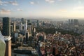 View from the window of a high-rise building to a modern city with skyscrapers, parks and sea coast Royalty Free Stock Photo