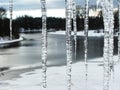 view through window with icicles at frozen river Royalty Free Stock Photo