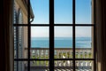 View from the window inside the room on the balcony with balustrades.