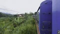 View from window of moving train in jungle. Action. Traveling train in midst of green forest in tropical mountains Royalty Free Stock Photo