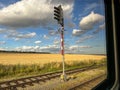 View from window of moving train at red traffic light in beautiful summer landscape Royalty Free Stock Photo