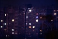 View from the window at night, light in the windows of apartments, a burning lantern, wet snow Royalty Free Stock Photo