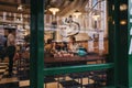 View through the window of people inside a restaurant in Covent Garden, London, UK.