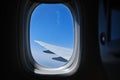 View through the window of the plane on Airplane wing on the blue sky Version2 Royalty Free Stock Photo