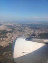 View from the window of the plane to the city of Lisbon and Portugal. Clear blue sky, aircraft engine and wing Royalty Free Stock Photo