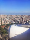 View from the window of the plane to the city of Lisbon and Portugal. Clear blue sky, aircraft engine and wing Royalty Free Stock Photo