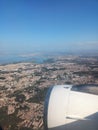 View from the window of the plane to the city of Lisbon and Portugal. Clear blue sky, aircraft engine and wing Royalty Free Stock Photo