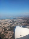 View from the window of the plane to the city of Lisbon and Portugal. Clear blue sky, aircraft engine and wing Royalty Free Stock Photo