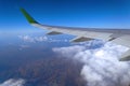 View from the window of the plane to the cumulus clouds and the infinitely blue sky.