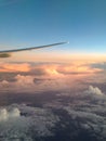 The view from the window of the plane to the wing and a fantastically beautiful sunset above the clouds