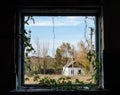 View from the window of a rustic house with trees and a blue sky Royalty Free Stock Photo