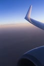 View from window seat during flight. Blue sky at sunrise. Wing. Airplane Royalty Free Stock Photo