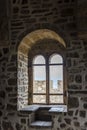 View of the window in the thick stone wall from inside the tower of Genoese fortress of 14th century in the Sudak bay