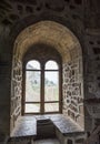 View of the window in the thick stone wall from inside the tower of Genoese fortress of 14th century in the Sudak bay on the