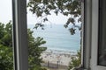 View from the window to the beach and the sea, the concept of a trip to the sea Royalty Free Stock Photo