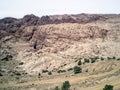 View from window of tourist bus on natural splendor of mountains with a tourist center near Wadi Musa city in which Petra is