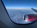 View from the window on the turbine and the wing of an airplane flying above the clouds Royalty Free Stock Photo