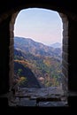 View from the window of a watch tower of the Mutianyu section of the Great Wall of China, surrounded by green and yellow Royalty Free Stock Photo