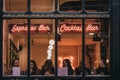 View through the window of women inside the Gring bar in Covent Garden, London, UK