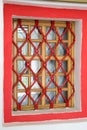 View Windows wood with twisted metal bars of red.