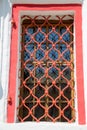 View Windows wood with twisted metal bars of red.