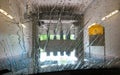 View through windscreen of car with water droplets inside car wash facility - Germany focus on droplets