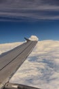 Aerial view of wing from jetplane blue sky and big white cloud background