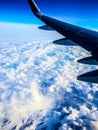 View of the wing of an airplane, clouds, earth