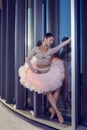 Dance Sport Ideas. Winsome Sexy Slim Professional Caucasian Ballet Dancer in Pink Tutu Dress Standing Against Metal Glass Royalty Free Stock Photo